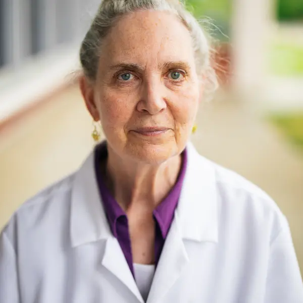 A woman smiles at the camera.